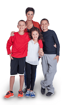 A woman stands behind three smiling children, all posing together as if ready for an online urgent care family photo.